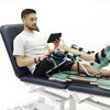 Image of Adjustable Leg Rehabilitation Machine Spectra CPM in use on treatment table with seated adult