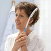 Image of Long Handled Hair Brush and Comb for Limited Mobility Grooming woman using extended reach comb to brush short hair