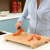 Image of Multi Purpose Food Preparation Board for One Handed Cooking peeling carrot on wooden board with spike holder