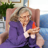 Image of Red Animatronic Bird Toy for Dementia in Palm of Elderly