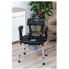 Image of Black King toilet commode chair beside the bed in a home bedroom