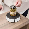 Image of Opening a pickle jar with one hand while the Easy-Up vacuum holder grips the jar to the bench