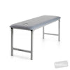 Image of fixed height metal plinth single section treatment table in clinic use