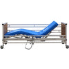 Image of K-Dee adjustable care bed side view with backrest raised, optional rails and mattress shown