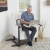 Image of Man working on a laptop at the Assist-A-Tray swivel table in an armchair