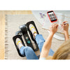 Image of Person pedalling the Cubii Go seated elliptical while writing at home