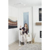 Image of Woman standing up from an armchair using the double handle floor to ceiling grab bar