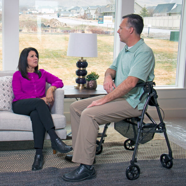 Stander EZ Fold-N-Go Rollator Sitting Down near Sofa