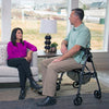 Image of Stander EZ Fold-N-Go Rollator Sitting Down near Sofa