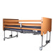 Folding Electric Profiling Bed for Community and Aged Care folded flat with wooden side panels and castor wheels