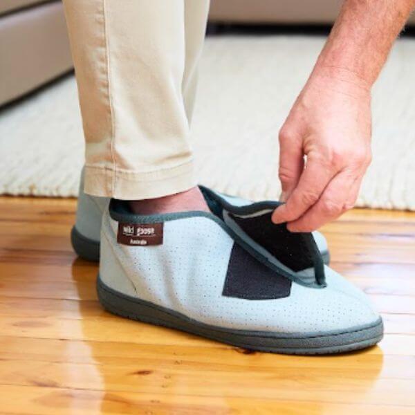 Man Strapping Sheepskin Wrap Around Boot