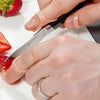 Image of Oval 8 Finger Splint Kit for PIP and DIP Joint Support used while cutting food showing finger protection and control