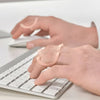Image of Oval 8 Finger Splint Kit for PIP and DIP Joint Support worn during typing on keyboard for finger support