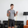 Image of Theraband Non-Latex Resistance Exercise Tubing for Strength Training man doing bicep curls with yellow tubing