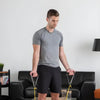 Image of Theraband Non-Latex Resistance Exercise Tubing for Strength Training man holding yellow tubing handles during workout