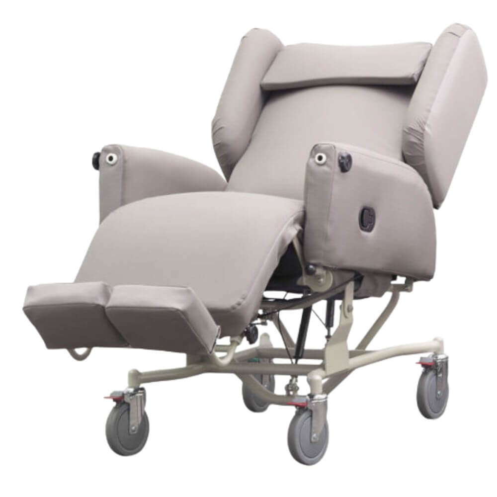 Tilt in Space Chair Bed with Pressure Relief and Recline shown upright with padded arms and wheeled base