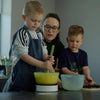Image of Children mixing batter in a bowl secured by the Easy-Up kitchen aid while baking with mum