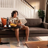 Image of Young man gaming with snacks on the Wonder Tray XL by the couch