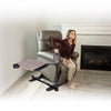 Image of Woman rising from her lift chair holding the assist handle
