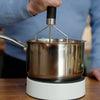 Image of Mashing potatoes one-handed in a saucepan held still by the Easy-Up vacuum base