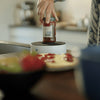 Image of Opening a sauce jar with one hand on the Easy-Up jar holder