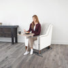 Image of Woman eating a meal at an over chair table in her armchair