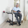 Image of Senior man reading with the swivel tray table and handle beside him