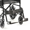 Image of Budget steel transit wheelchair swing away footrests and rear wheel close up