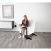 Image of Woman eating at a couch tray table with stand assist handle