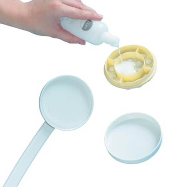 Dual Function Lotion and Cream Applicator Placing Cream in Compartment