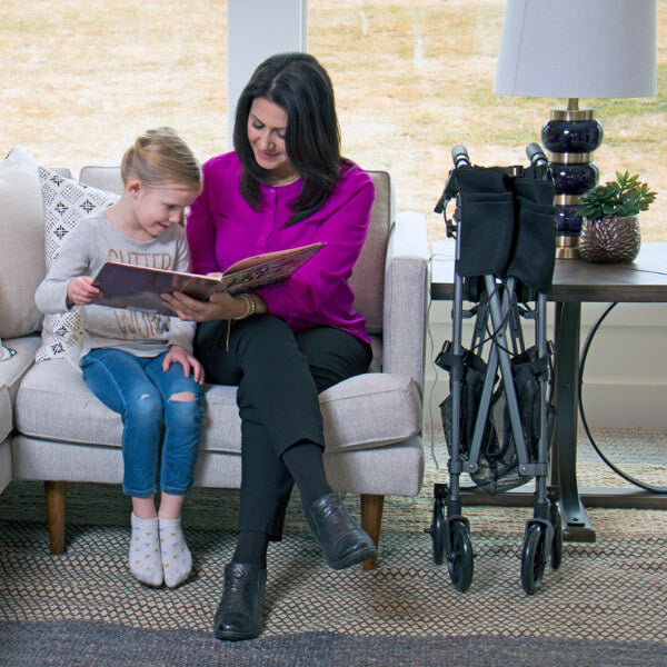 Stander EZ Fold-N-Go Rollator Folded Near Sofa